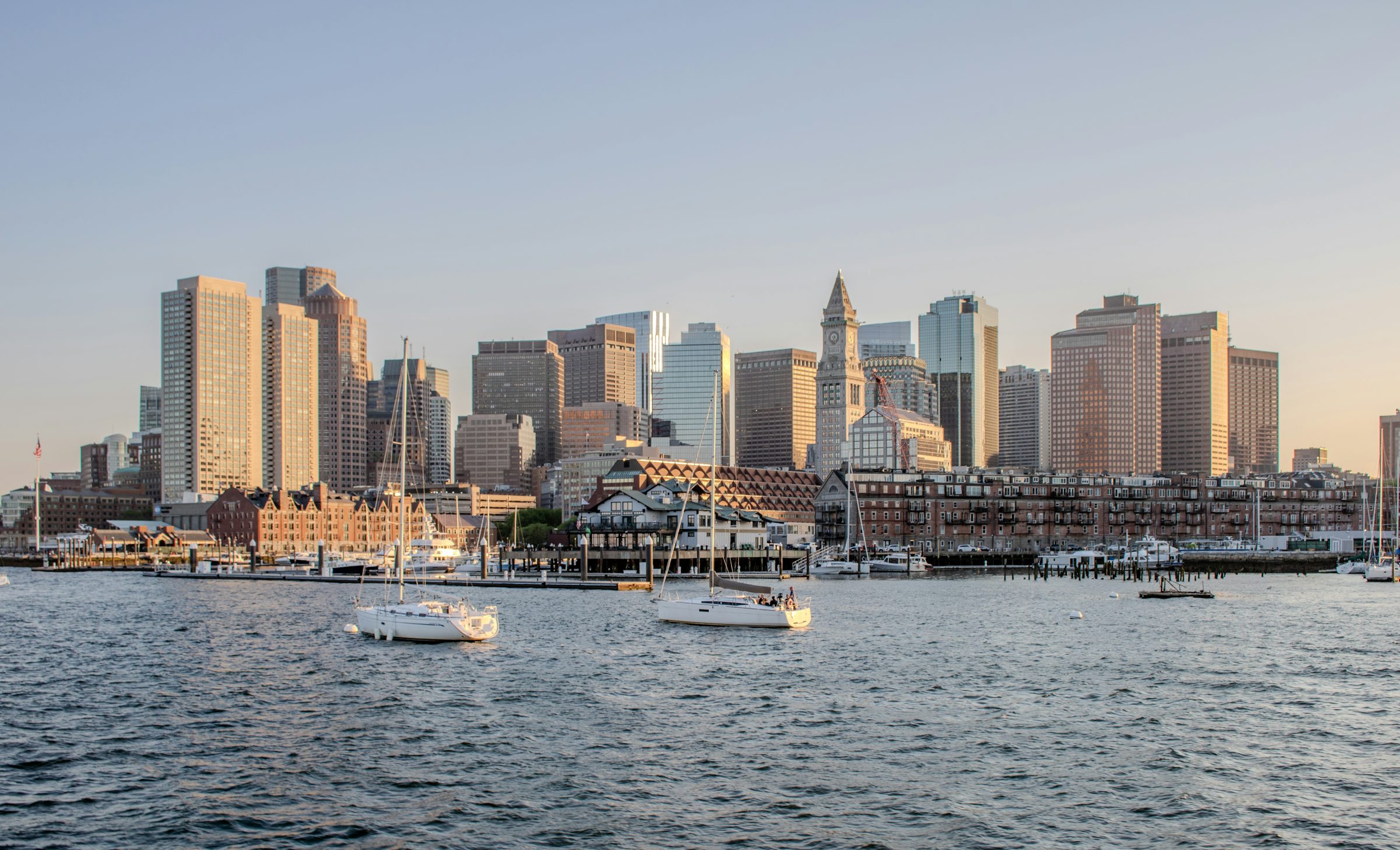 Harbor with city skyline at sunset