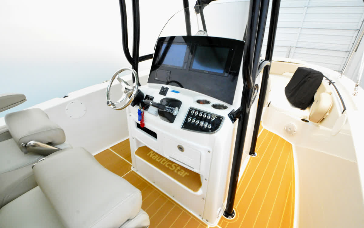 Boat helm console with steering and navigation displays